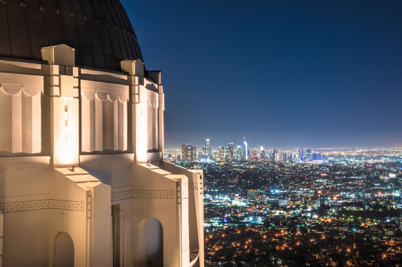 A glowing observatory above the skyline under golden fog